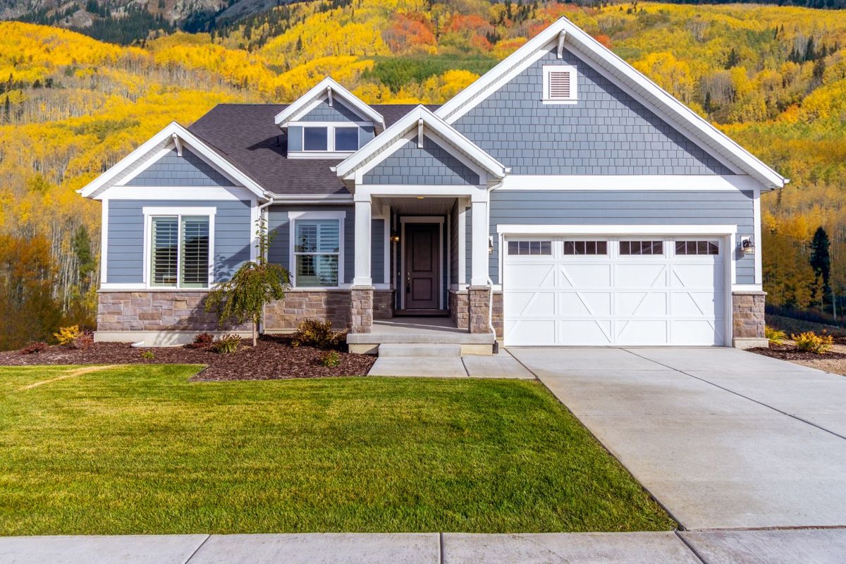 Suburban home with blue horizontal siding and white trim.